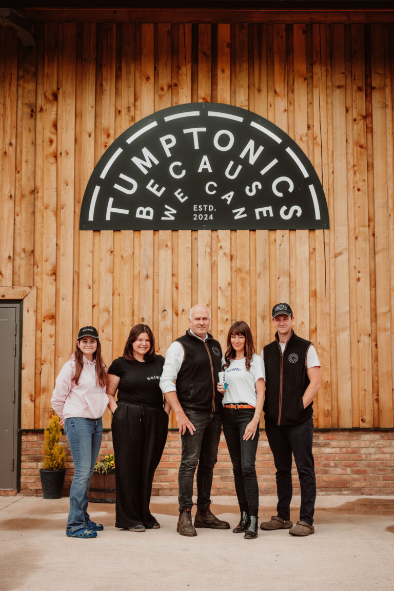 A Tumptonics Team Photo of staff infront of the production unit. From left to right: Amelia Worsley Angharad Worsley Mark Williams Sara Jones (Founder) Dominic Hampson-Smith