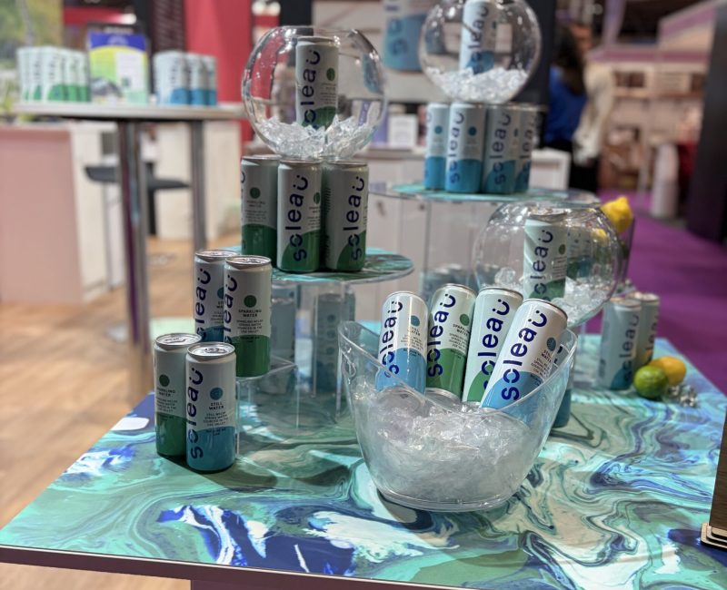 This image is of the Soleau and Tumptonics stand at the Farmshop and Deli Show 2026. The stand is brightly coloured with both blue and greens, representing both the still and sparkling water.